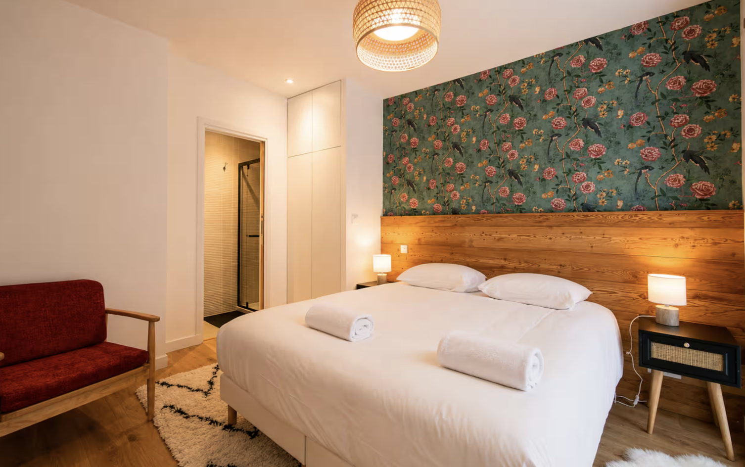 Bedroom with floral wallpaper and en-suite shower room